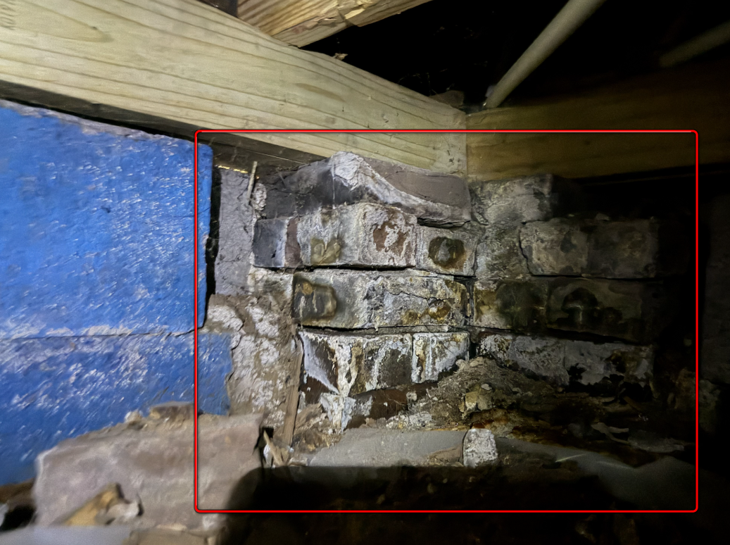 Crumbling brick support pier with deteriorated original lime mortar.