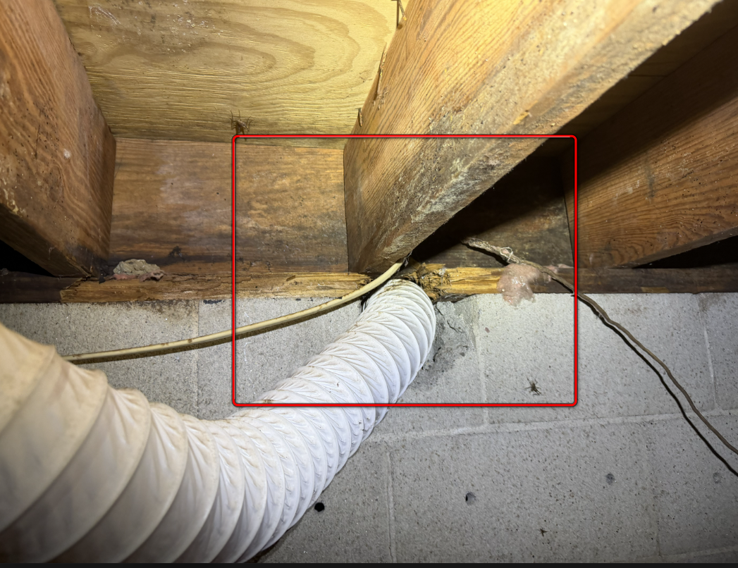 Dryer vent duct improperly cut through structural wooden sill plate.