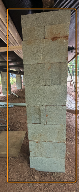 Dry-stacked concrete block pier improperly leveled under floor support.