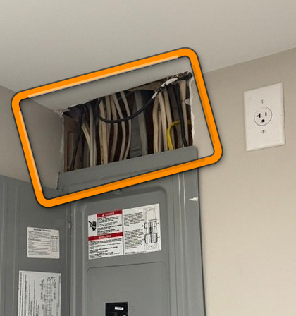 Exposed interior Romex electrical wiring vulnerable to physical damage.