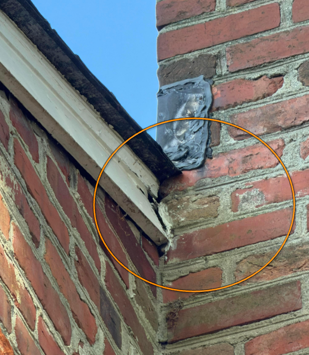 Rotting fascia board showing moisture entry and wood decay at gutter line.