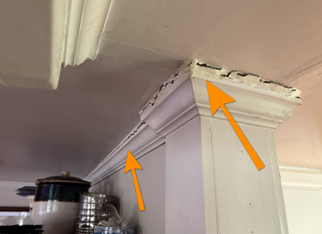 Cracked interior door casing trim indicating potential foundation settlement movement.