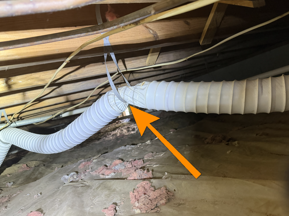 Kinked and crushed flexible dryer vent duct posing lint restriction and fire hazard.