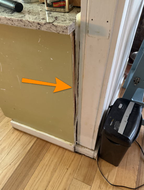 Gap between kitchen cabinet and wall suggesting structural floor movement.