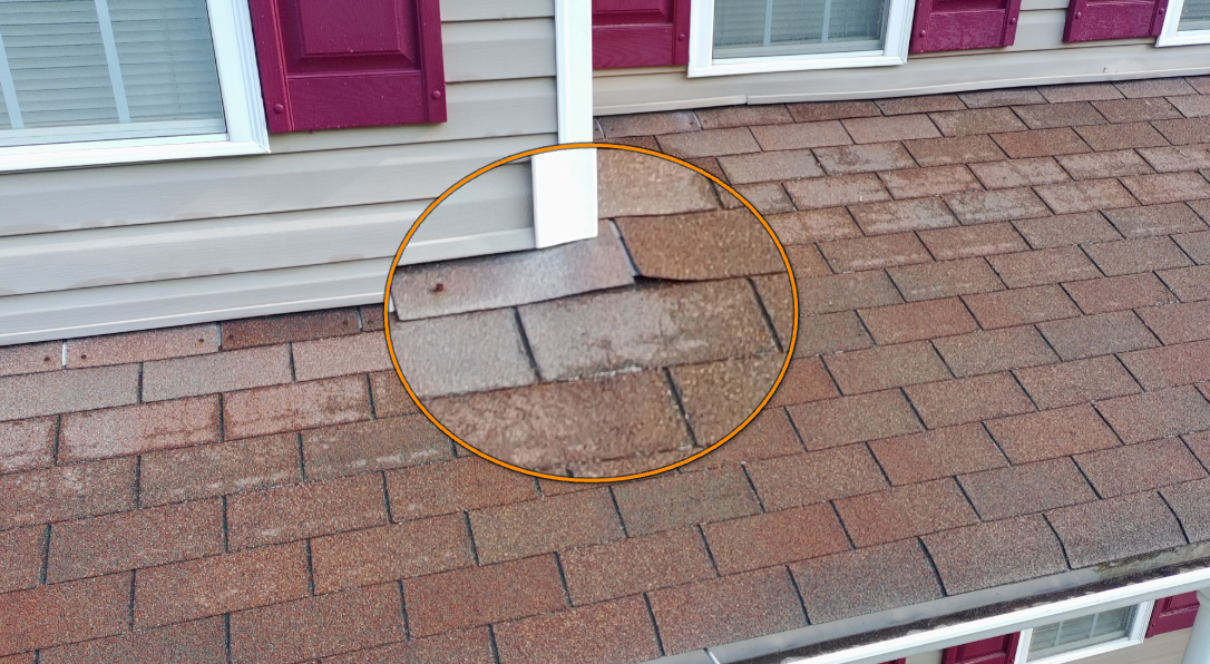 Lifted and unsealed roof shingle exposed to wind lift.