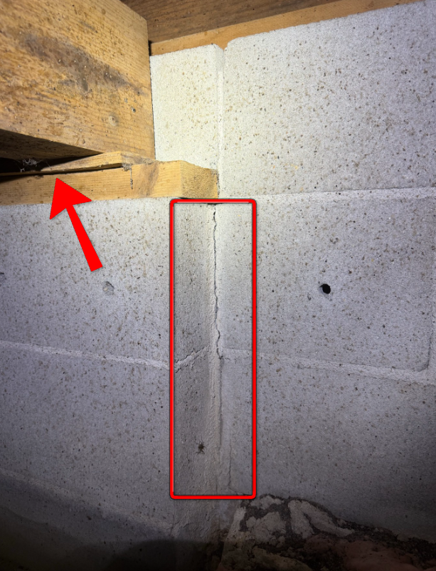 Cracked masonry pilaster needing structural engineering review.