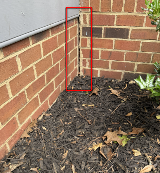 Separation gap in exterior brick veneer masonry wall.